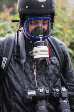 Journalist wearing a gas mask